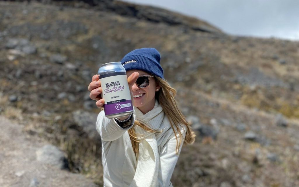a woman holds a can of inmaculada snapchilled coffee