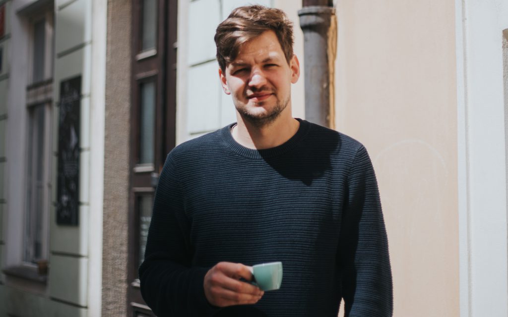 Zdenek Hybl holds a cup of coffee in Prague.